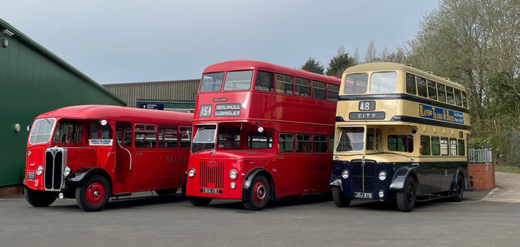 row of 3 vintage buses